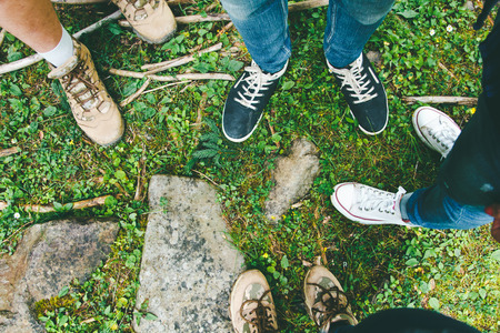 Hiking shoes on hiker outdoors walking crossing river creek. Woman  and men on hike trekking in nature. Close up of hiking boots.の写真素材