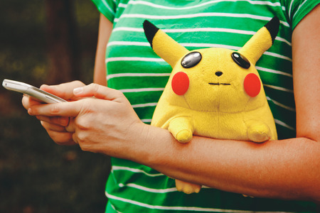 Victory Park in Poltava, Ukraine - September 03.09.2016: soft toy Pikachu in the hands of the girls. Toy PokÃ©mon from the famous cartoon and game pokemon go.のeditorial素材