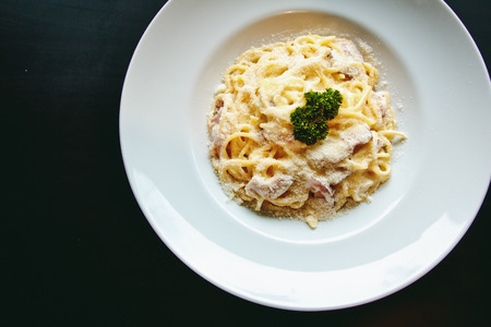 Classic Pasta carbonara Italian with Parmesan Cheese on black backgroundの写真素材