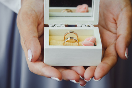 Beautiful wedding rings in the hands the brideの写真素材
