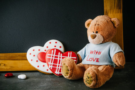 Beautiful background for Valentine's day with Teddy bear and gingerbread hearts. Free space for your...