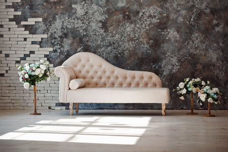 luxury white sofa in living room with bouquet of flower in vase at home