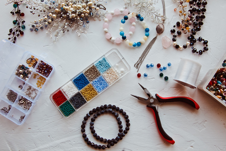 Sets of beads and beads along with finished jewelry. The concept of handmadeの写真素材