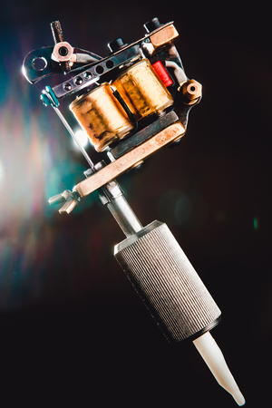 Induction tattoo machine on black background.の写真素材
