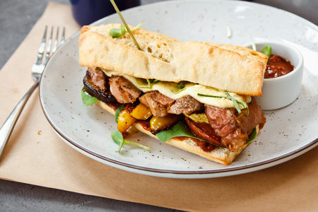 Beautiful fresh steak sandwich on a white plateの写真素材