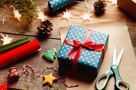 Beautiful Christmas background with a New Year dÃ©cor, a sheet of old paper, garland and gifts on a wooden background. Merry Christmas postcard.の写真素材
