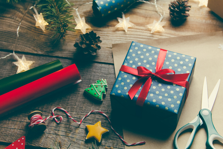 Beautiful Christmas background with a New Year dÃ©cor, a sheet of old paper, garland and gifts on a wooden background. Merry Christmas postcard. の写真素材