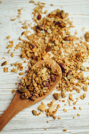 Spoon with granola, on white background.の写真素材
