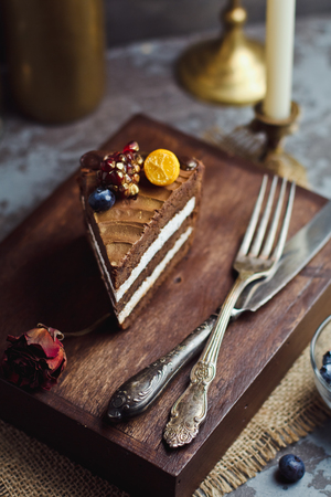 A piece of chocolate cake on wooden background. Happy birthday backgroundの写真素材
