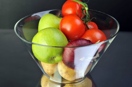 tomato apple onion and potato in vaseの写真素材