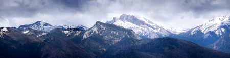 Snow-covered mountains under the dark skyの写真素材