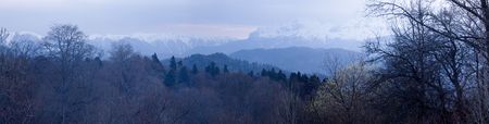 Snow-covered mountains under the dark skyの写真素材