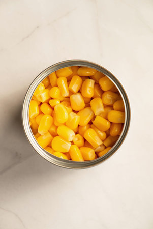 Canned sweet corn in opened tin can, top view.の写真素材