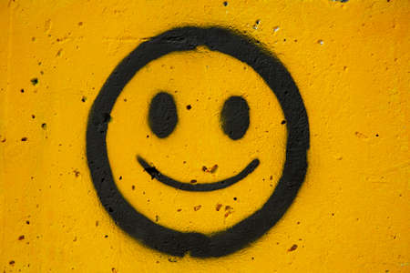 A smiley face drawn on concrete.の写真素材