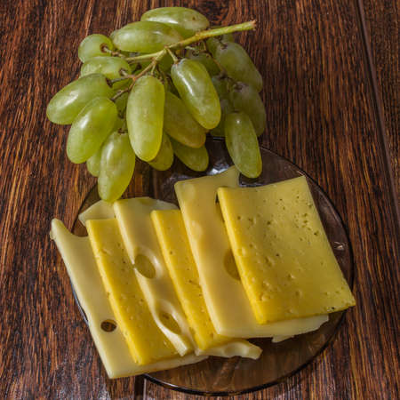 Sliced cheese and grapesの写真素材