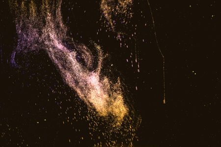 Dance of small gas bubbles in a colored liquid. Bubbles of gas in the wine. Carbonated Christmas drink. Nebula, star cluster in the dark sky.の写真素材