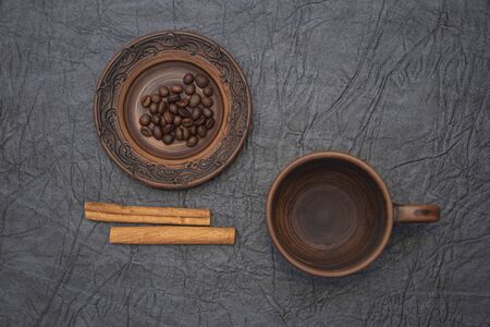 Homemade cup and saucer made of glazed clay.の写真素材