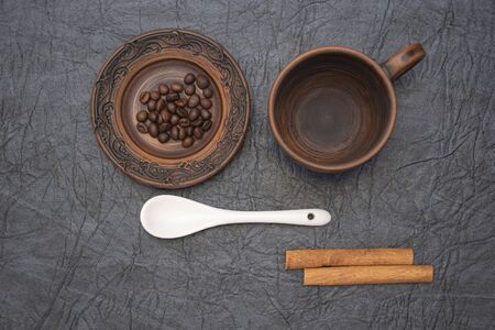 Homemade cup and saucer made of glazed clay.の写真素材