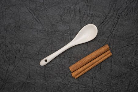 White glazed porcelain coffee spoon on artificial leather background.の写真素材