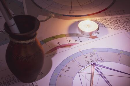 The workplace of a modern astrologer. Accessories of an astrologer. Printouts of computer astrological maps and tables. Astrological symbols and signs.の写真素材