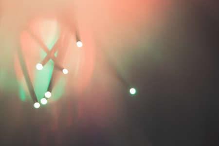 Abstract background. Fantastic fancy plants with colored branches with luminous dots at the ends. Lamp from a panicle of optical fibers on a dark background.の写真素材