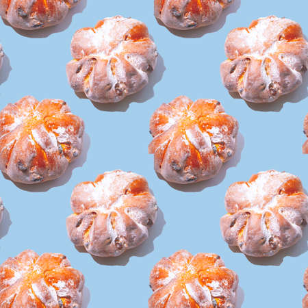 Seamless pattern of rosy buns sprinkled with icing sugar. Allow yourself to feast on junk food after prolonged quarantine.の写真素材