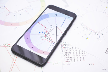 A modern astrologers gadget. A smartphone with a clients astrological chart.