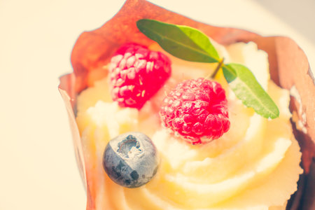 Cheesecake with bright sweet berries of raspberries and blueberries. Cheesecake wrapped in an...