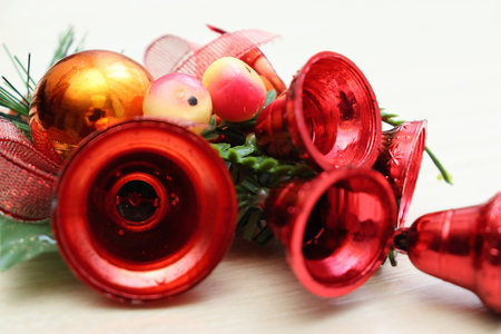Merry christmas and a happy new year! Bright holiday decorations close-up. Plastic bells and pine twigs.の写真素材
