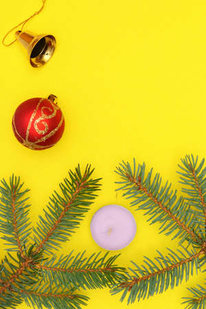 Merry christmas and a happy new year! A sprig of the green symbol of the winter holidays - spruce with decorations on a plain background and free space for an inscription.の写真素材