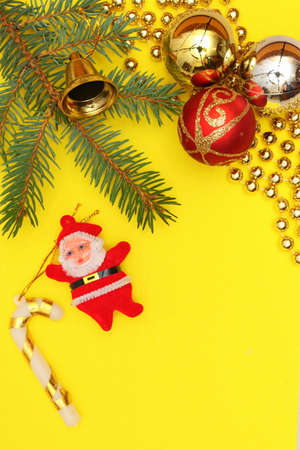 Merry christmas and a happy new year! A sprig of the green symbol of the winter holidays - spruce with decorations on a plain background and free space for an inscription.の写真素材