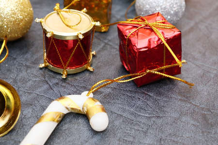 Merry christmas and a happy new year! A sprig of the green symbol of the winter holidays - spruce with decorations on a background of gray artificial leather backing.の写真素材