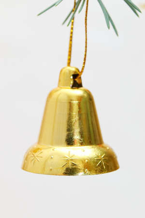 Merry christmas and a happy new year! The atmosphere of the winter holidays. Green spruce branch with decorations on a light background and free space for an inscription.の写真素材