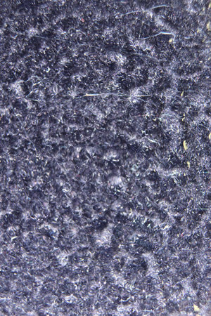 Black velvet fabric through drops of water on the glass