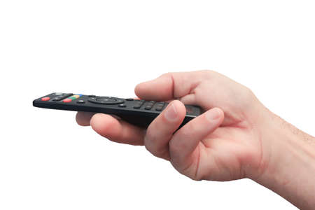 A man's hand with a close-up remote control. Black remote control with colored buttons. Isolate on a white background.の写真素材