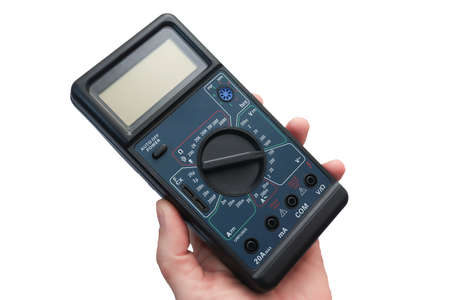 Hand master with close-up electronic multimeter. Black multimeter with LCD screen and plenty of measurement limits. Isolate on a white background.の写真素材