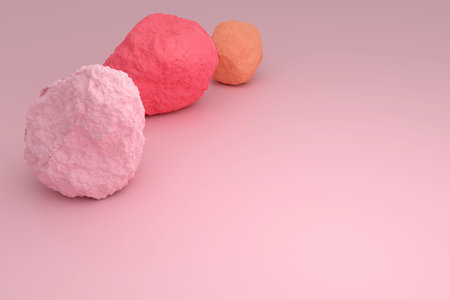 Multicolored stones on a pink surface. Pink, red and brown stones in the corner of the frame. Free...