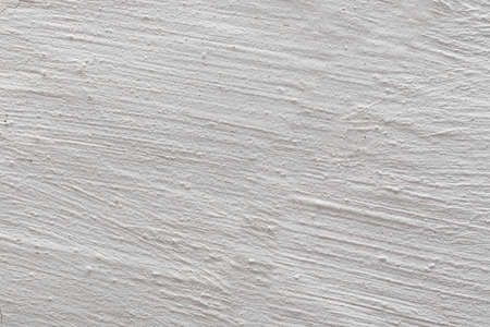 The background is in the form of gray rough plaster on the wall, whitewashed with chalk.の写真素材
