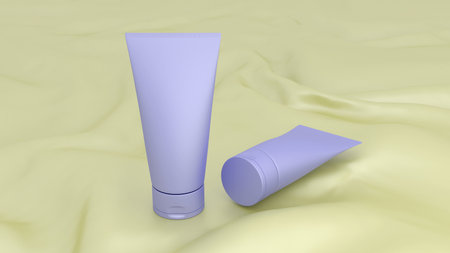 Two blue tubes on a yellow fabric for cosmetic products. Blank for mockup.の写真素材