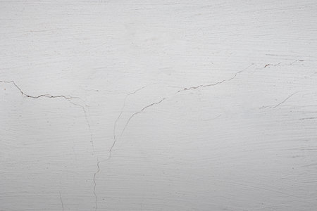 Plastered wall and whitewashed with chalk. Old cracked plaster on the wall.の写真素材