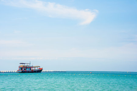 Passenger ship or ferry at the pier on the background of the blue sea, the concept of summer tourism, active recreation in Thailandの写真素材