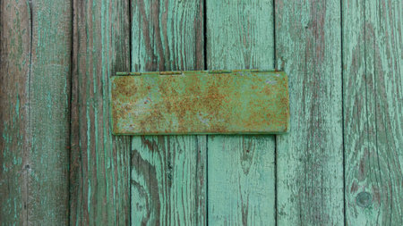green painted wall, background with a rusty sign for the inscriptionの写真素材