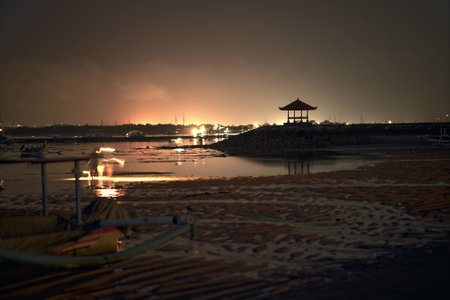 Landscape of sunset sea beach. The evening sky reflects on the wet sand. Sunset on the sea surface. Beautiful sunrise over a tropical beach.の写真素材
