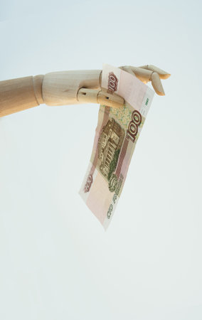 Money in hand. Imitation of a hand holding shows a hundred-ruble bill. The concept of finance, money investments, receiving money. Copy Spaceの写真素材