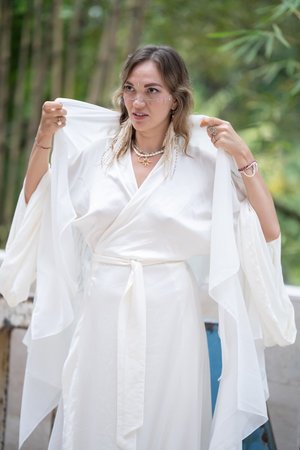 Portrait of a full-length woman standing in a business white suit, a beautiful young businesswomanの写真素材
