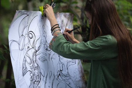 a girl draws a close-up of a beautiful and seductive woman on canvas, drawing something modern and...