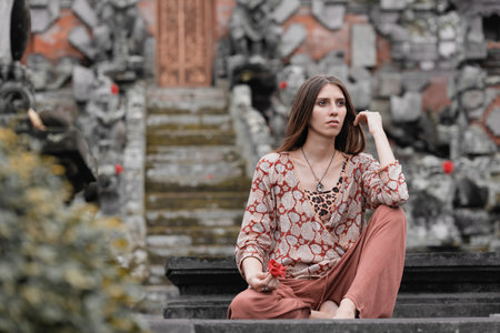 a model girl meditates near a shrine, poses for a temple in a tropical forest, long hair 4kの写真素材