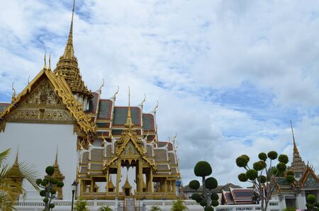 Thailand, Bangkok, the Royal Palace and the temple of the emerald Buddha against the blue sky and white cloudsの写真素材