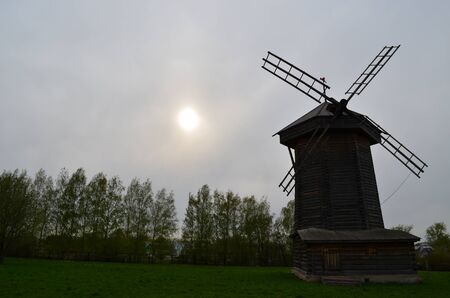 wooden windmill on the background of the rising sunの写真素材