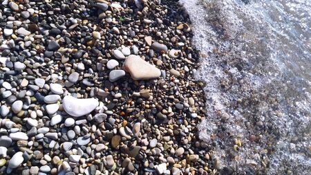 on the rocky shore of the sea are footprints of stonesの写真素材